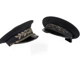 pair of black hats with gold embroidery on them on a white background