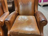 pair of leather recliners with footstools and foot rest