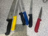 four knives that are sitting on a counter top