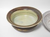 a brown and white bowl sitting next to a brown and white bowl