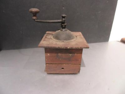 an old coffee grinder sitting on a table