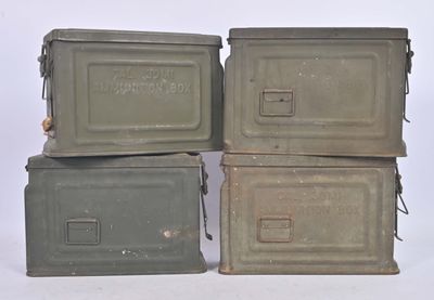three old metal boxes stacked on top of each other on a white surface
