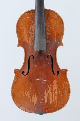 a close up of a violin on a stand with a white background
