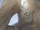 a close up of a bronze statue of a person