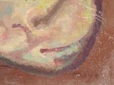 a painting of a woman ' s face on a brown surface