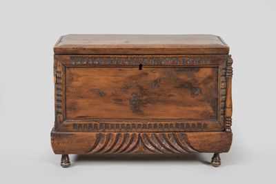 an old wooden chest with a drawer on top of it