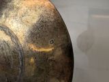 a large metal vase with a clock on it