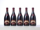 four bottles of wine lined up on a table