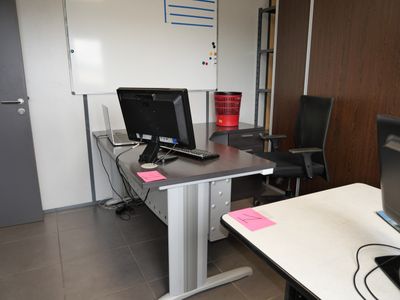 a desk with two monitors and a laptop on it