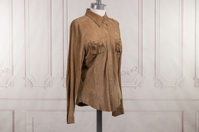 brown sued jacket with fringes on a mannequin base
