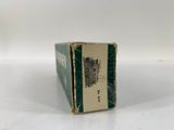 a small box with a label on it sitting on a white surface