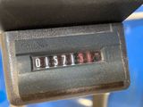 a close up of a clock on the back of a bus