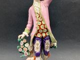 an image of a figurine of a man with a dog