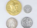 four different types of coins are shown on a white surface