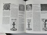 an open book on a table with a bunch of pictures on it