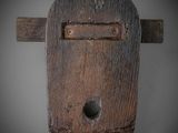 a wooden cross with a hole in the middle of it