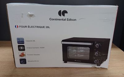 boxed box of a toaster oven sitting on a wooden table