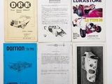 several books on a white table with a black and white photo of a car