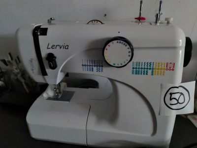 a white sewing machine sitting on top of a table
