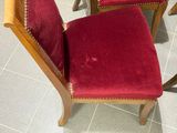 a red chair that is sitting next to a table