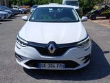the front view of a white car parked in a parking lot