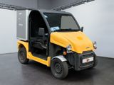 a small yellow truck parked inside of a building