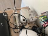 a desk with a laptop, mouse, and other items on it