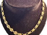 a close up of a hat with a necklace on a mannequin