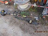 a corded pole with a string attached to it next to a fire hydrant