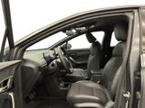 the interior of a car with the door open and the driver ' s seat down