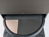 an open laptop computer sitting on top of a stand on top of a white surface