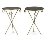 a pair of black and gold side tables with metal legs
