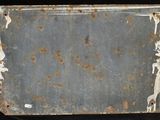 an old suitcase sitting on a black surface with rusted paint