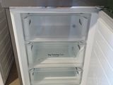 an open refrigerator with the door open in a kitchen