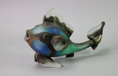 brightly colored fish figurine on a white surface with a white background