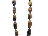 a close up of a necklace with tiger eye beads on a white background
