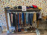 a rack of clothes and shoes on display in a room