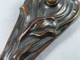 a close up of a metal object with a flower on it