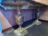 two vases sitting on a table in the corner of a room