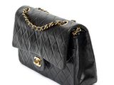 a black chanel bag with gold hardware and chain