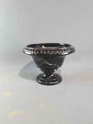 an image of a black vase sitting on top of a white table