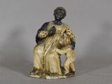 an image of a figurine of a woman sitting on a chair
