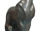 statue of a dog sitting on its hind legs on a white background