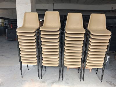 six chairs stacked on top of each other in a garage