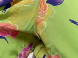 a close up of a woman ' s shirt with flowers on it