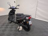 a scooter parked in a room with a checkered floor