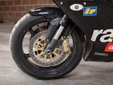 a close up of a motorcycle parked in front of a brick wall