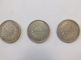 three silver coins, one of which is a sovereign and one of which is a sovereign