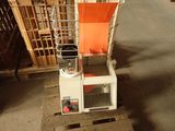 a picture of an orange chair sitting on top of a wooden pallet