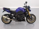 a picture of a blue motorcycle parked in a room